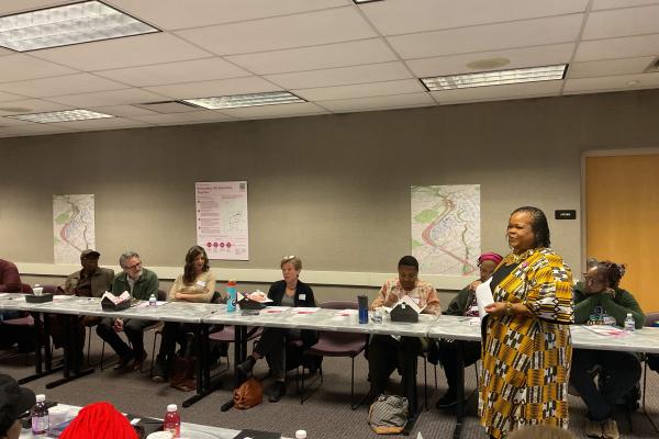 Ebony Hill giving a presentation to a group of community members.