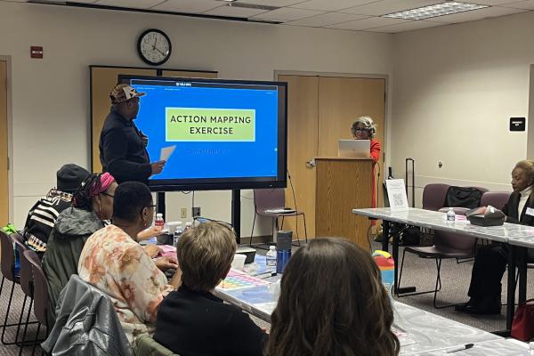 Carla Davis and a community member leading a discussion