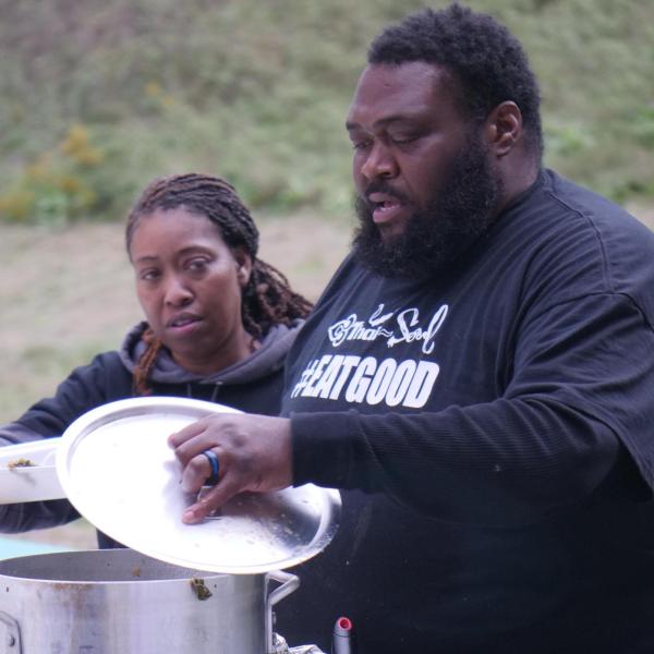 Two chefs serve food at Open Streets event