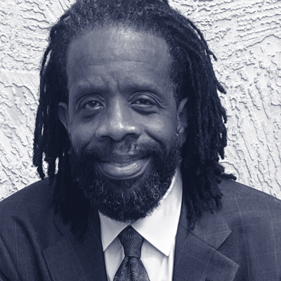 Black man in suit with blue tie